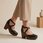 Black closed-toe platform wedge sandals with ankle strap and cross straps