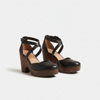 Black closed-toe platform wedge sandals with ankle strap and crisscross upper, pair