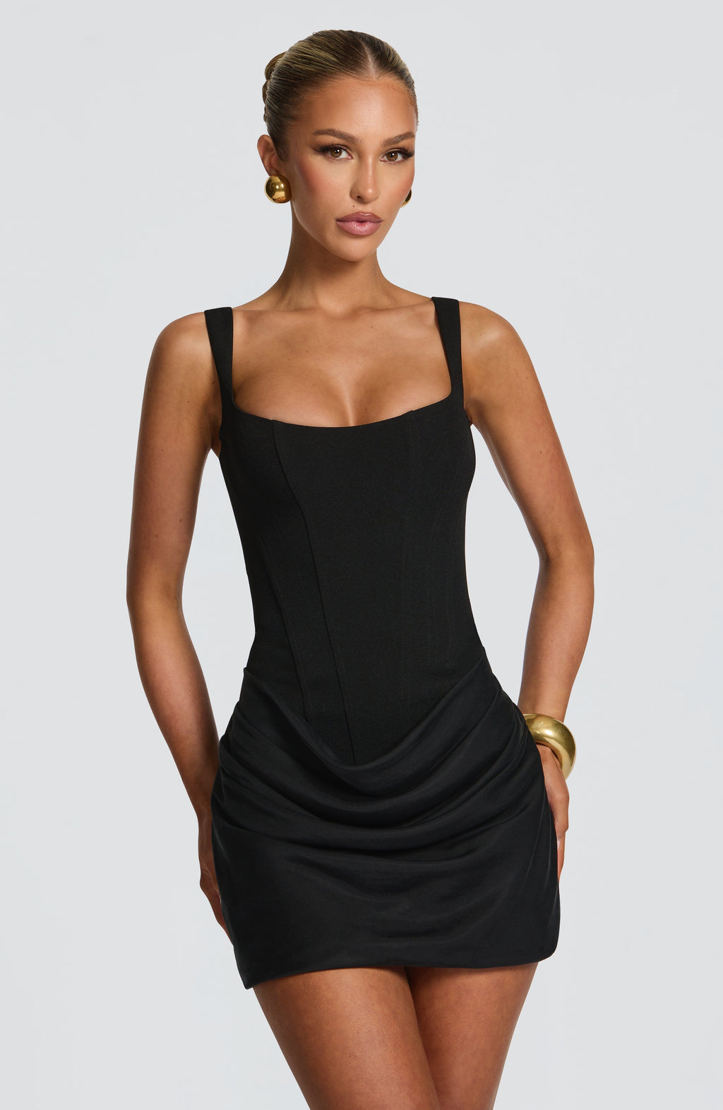 Black square-neck mini dress with boned bodice; draped ruching at skirt, thin straps
