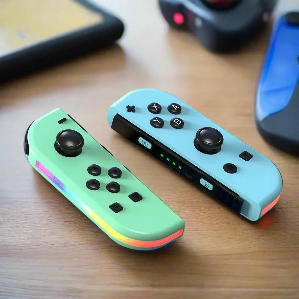 Mint green and light blue Nintendo Switch RGB LED joy-con controllers on a wooden table.