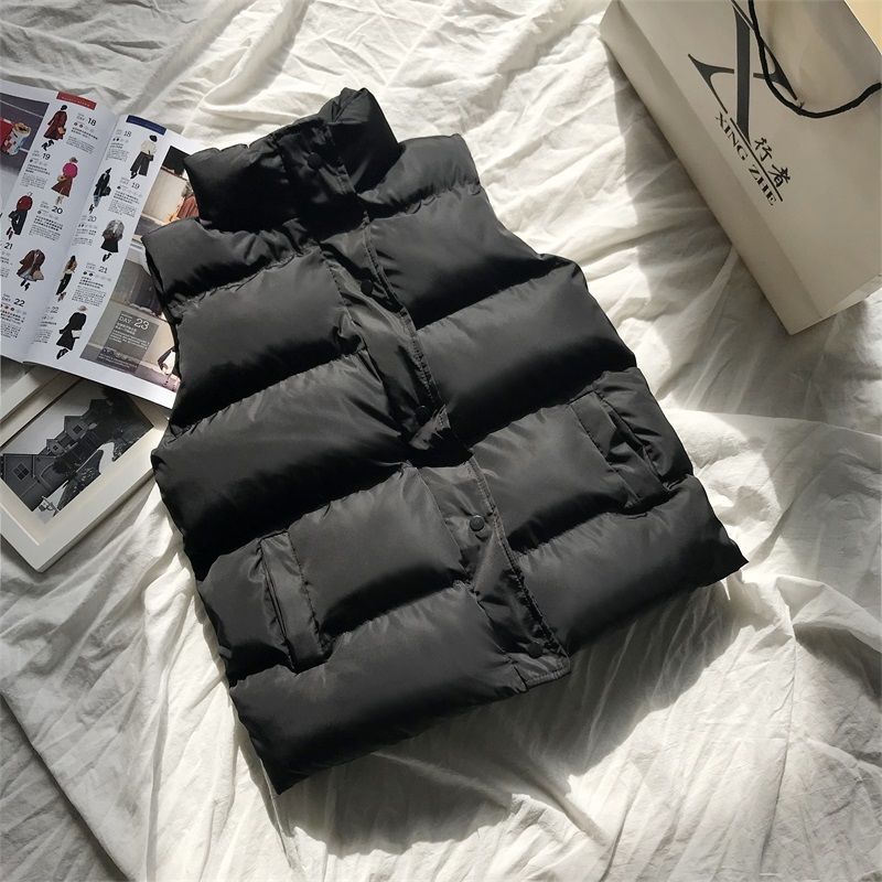 Black quilted puffer bodywarmer with zip front and stand collar, horizontal quilting