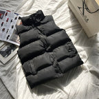 Black quilted puffer bodywarmer with zip front and stand collar, horizontal quilting