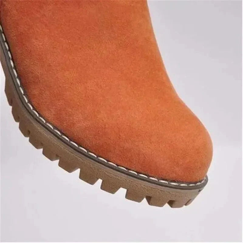 Women’s suede winter boots in orange with beige outsole and stitched edge