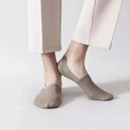 Khaki no-show socks on feet, low-cut ankle style