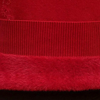 Red knitted sweater fabric close-up: ribbed trim and textured hem