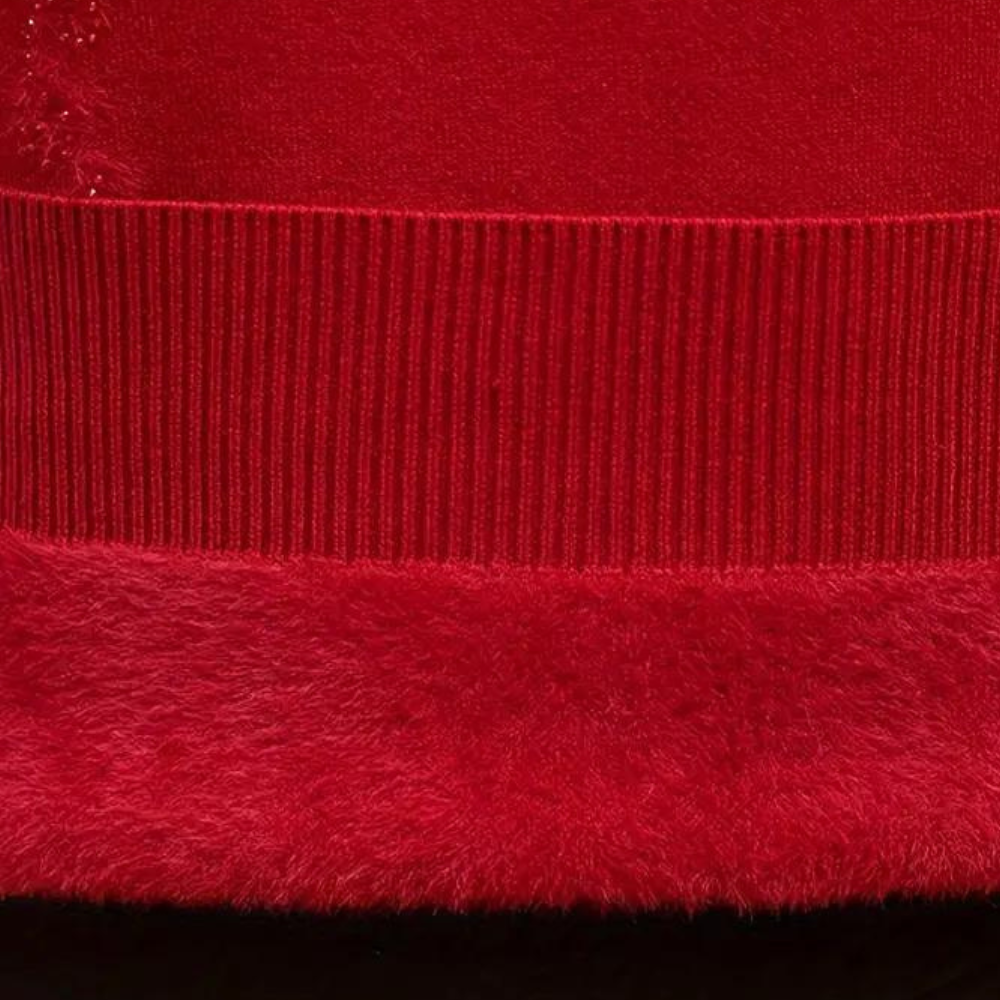 Red knitted sweater fabric close-up: ribbed trim and textured hem
