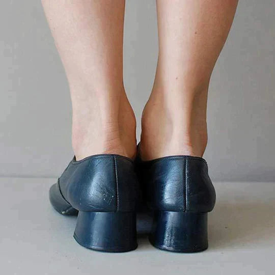 Navy Mary Jane shoes with adjustable buckle strap, back view of block heel