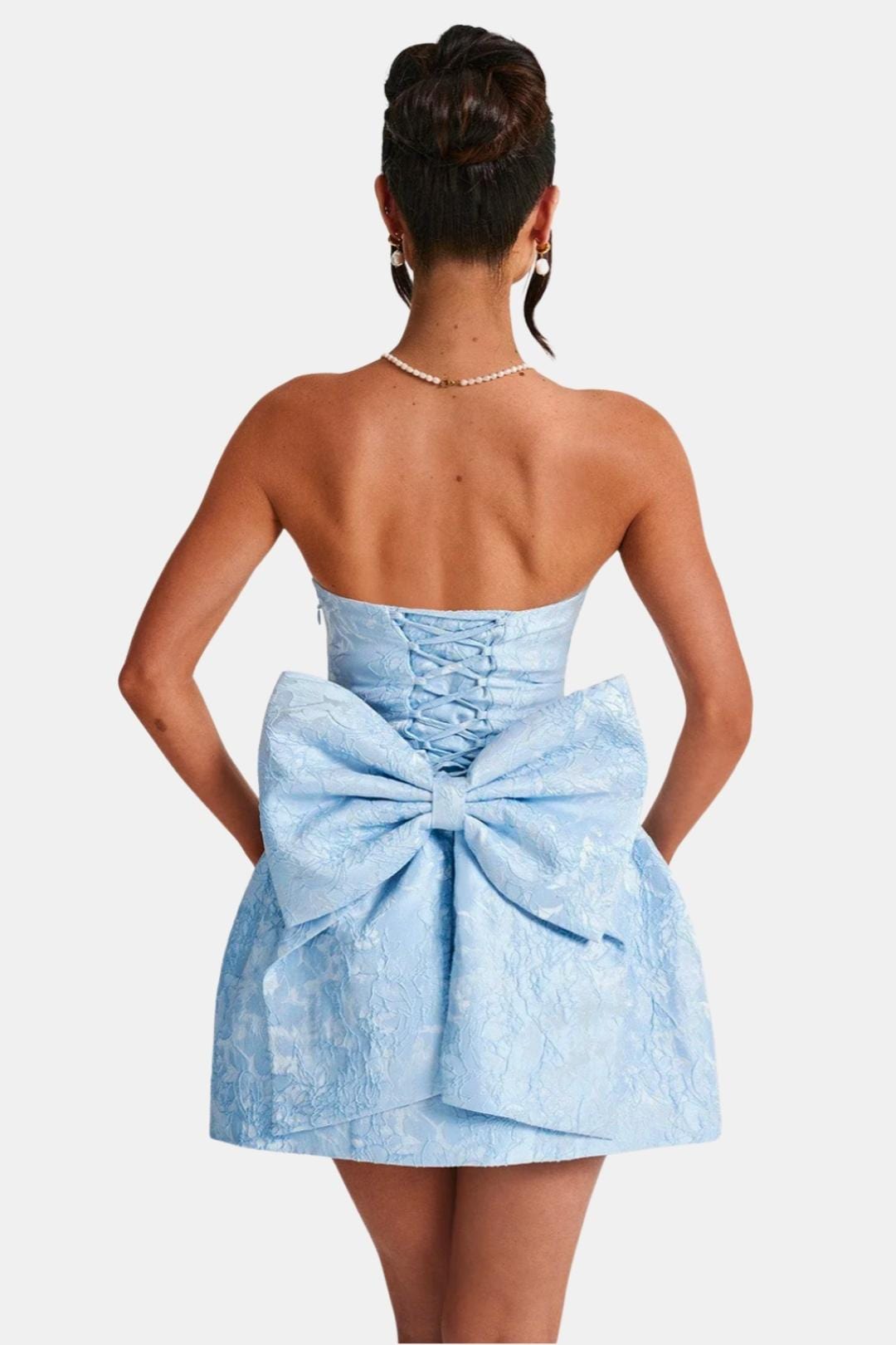 Light blue strapless mini dress, back view with floral jacquard and bow-tie at waist