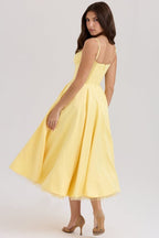 Yellow corset-style sleeveless midi dress with spaghetti straps and full twirled skirt.