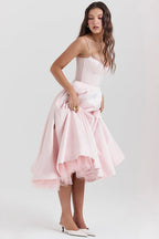 Blush pink corset-style sleeveless midi dress with spaghetti straps and layered flared skirt.