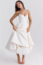 White corset-style sleeveless midi dress with sweetheart neckline and layered flared skirt.