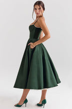 Green corset-style sleeveless midi dress with structured bodice and gathered flared skirt.