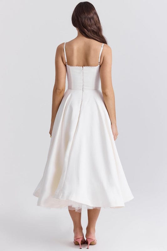 White corset-style sleeveless midi dress with spaghetti straps and flared skirt.