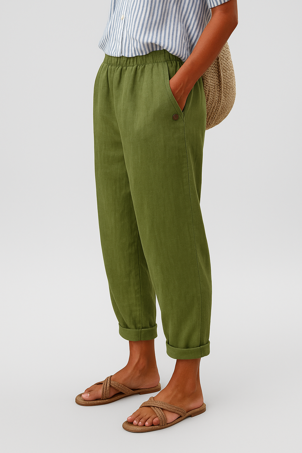 Green women's pants with elastic waist, side seam pockets, button detail, ankle cuffs