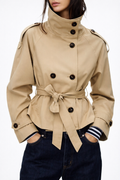 Women's beige trench coat with double-breasted buttons and tied waist belt