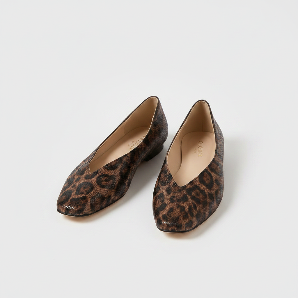 Pair of leopard print slip-on loafers with rounded toe and tan interior lining