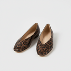 Pair of leopard print slip-on loafers with rounded toe and tan interior lining