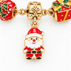 Gold tone charm bracelet with red-and-green Christmas ornaments, gifts, and a snowman charm