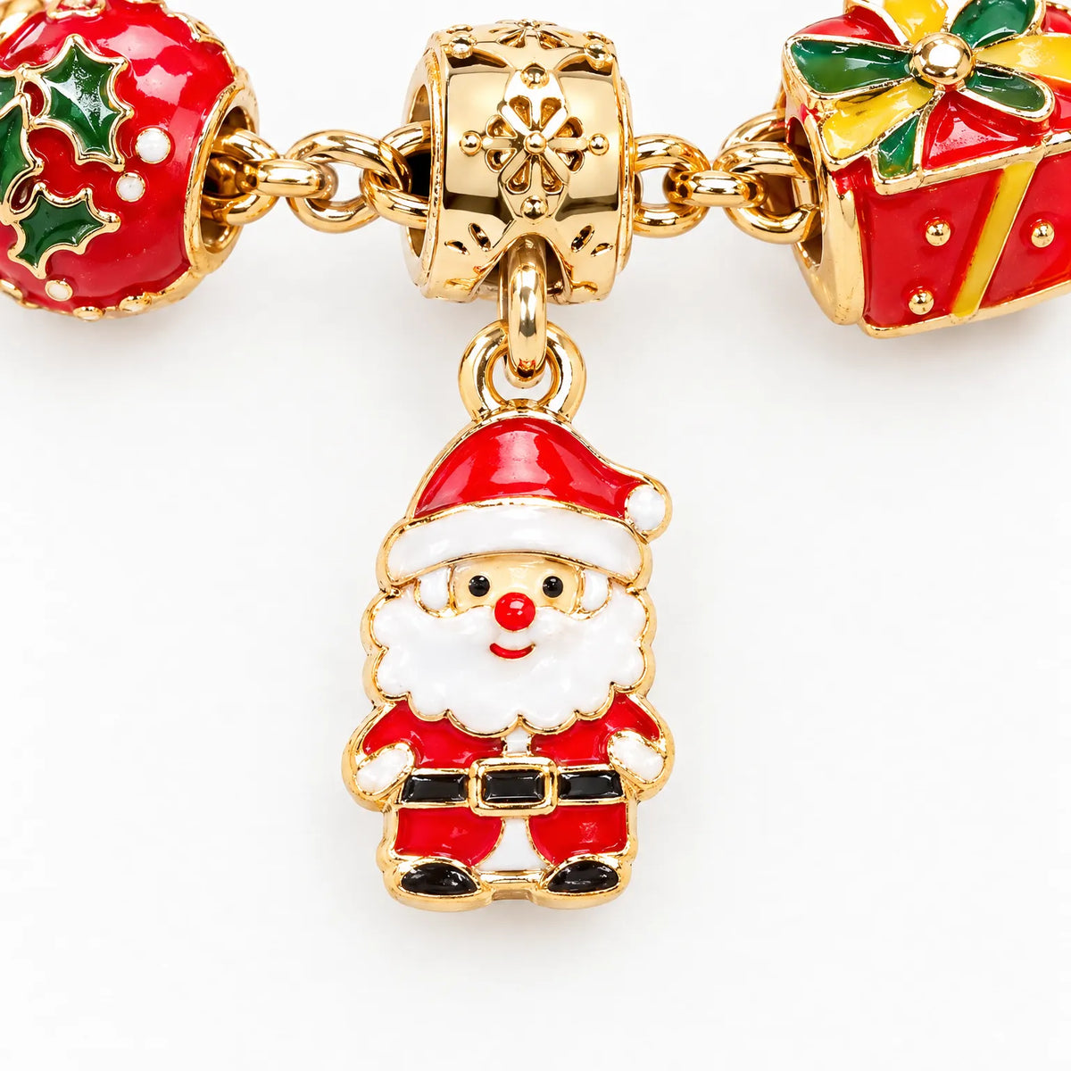 Gold tone charm bracelet with red-and-green Christmas ornaments, gifts, and a snowman charm