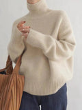 Women's beige turtleneck sweater with chunky ribbed cuffs and smooth knit body