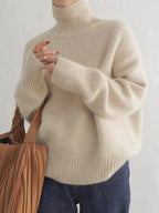 Women's beige turtleneck sweater with chunky ribbed cuffs and smooth knit body
