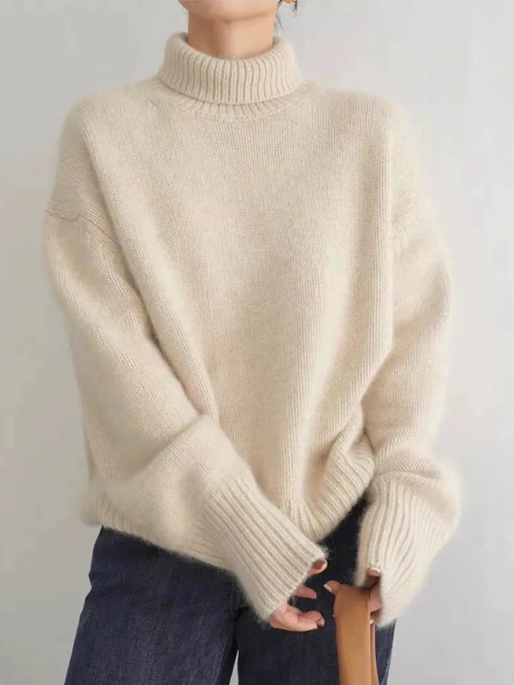 Women's beige turtleneck knit sweater with ribbed collar, cuffs, and hem
