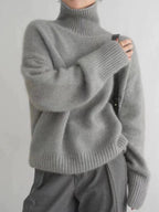 Women's gray turtleneck knit sweater with ribbed cuffs and relaxed fit sleeves