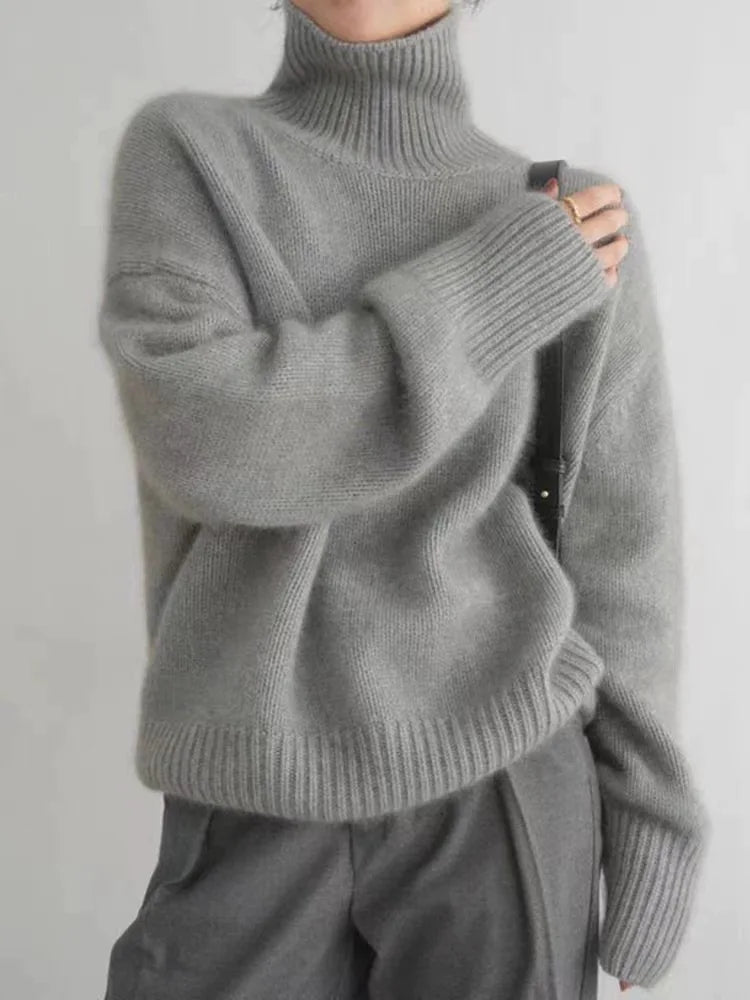 Women's gray turtleneck knit sweater with ribbed cuffs and relaxed fit sleeves