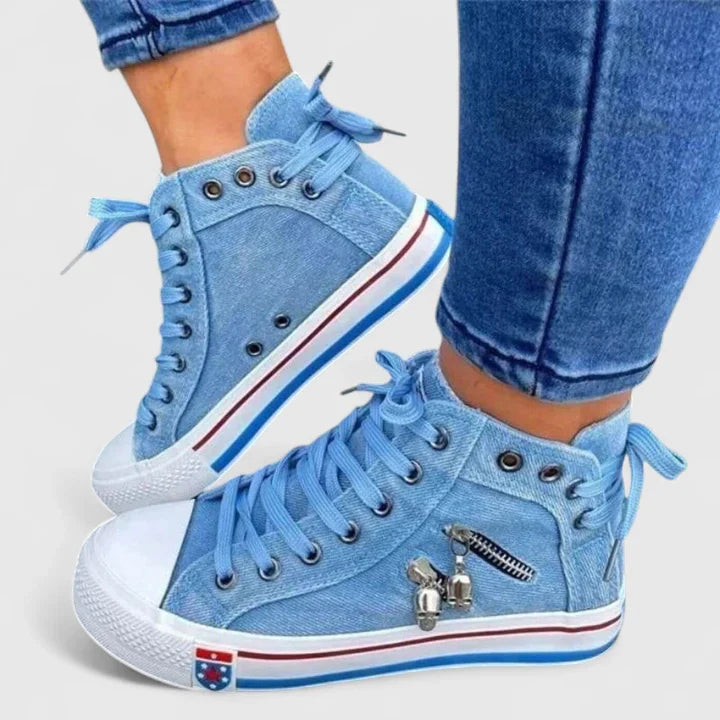 Light blue denim high-top sneakers with lace-up front and metal charm zipper detail