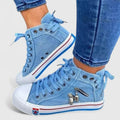Light blue denim high-top sneakers with lace-up front and metal charm zipper detail