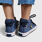 Navy blue denim high-top sneakers with lace-up closure and striped trim on the heel