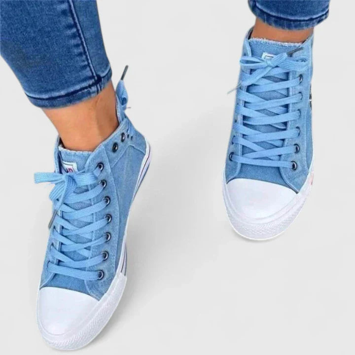 Light blue denim high-top sneakers with white rubber toe cap and lace-up front