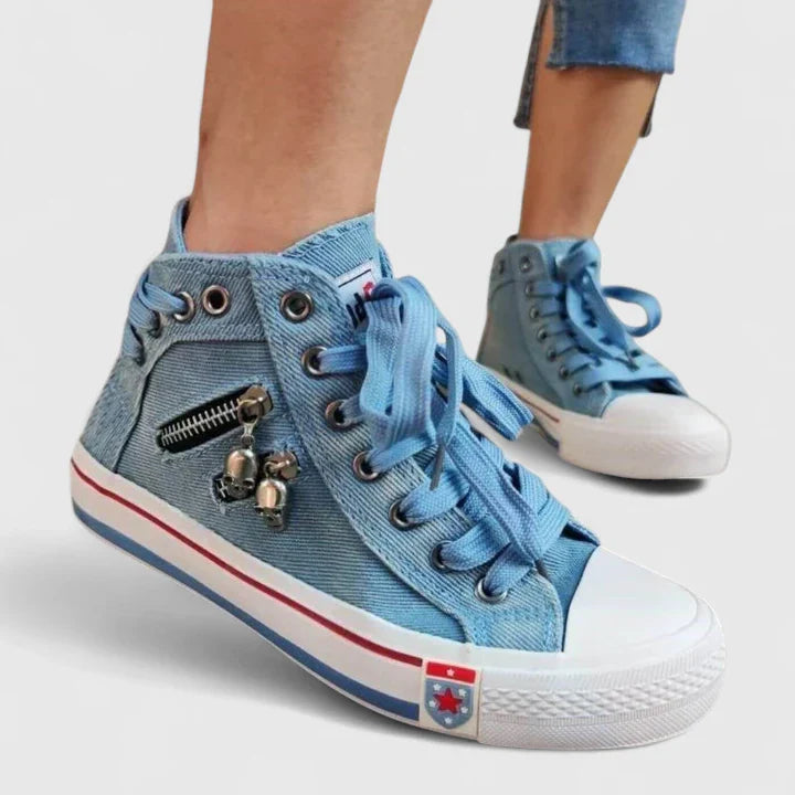 Blue denim high-top sneakers with lace-up front, side zipper detail, and metal charms