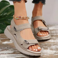 Women’s beige sandals with two adjustable straps, open toe, and chunky sole