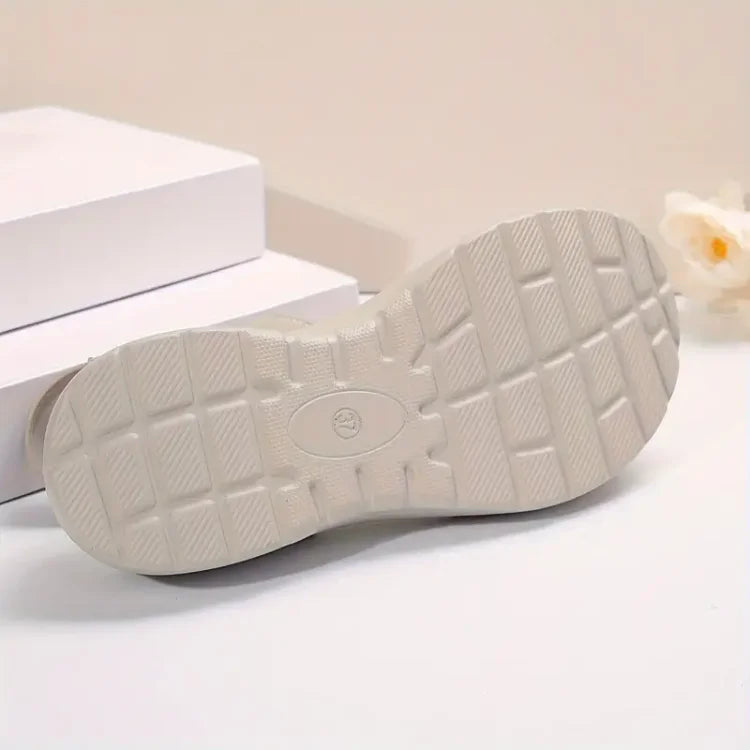 Women’s light-colored sandal outsole with textured tread and grip pattern