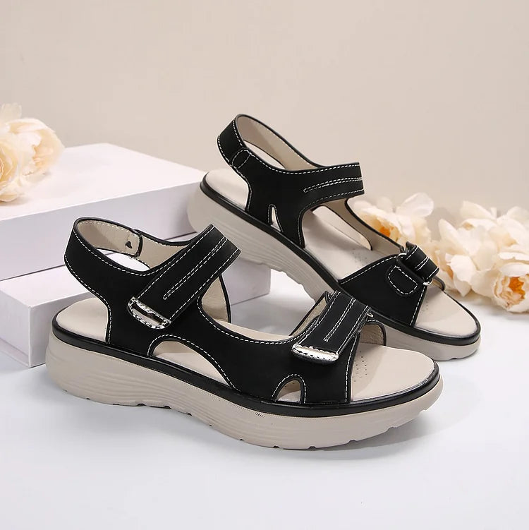 Women’s black sandals with two adjustable straps and cushioned, sport-style sole