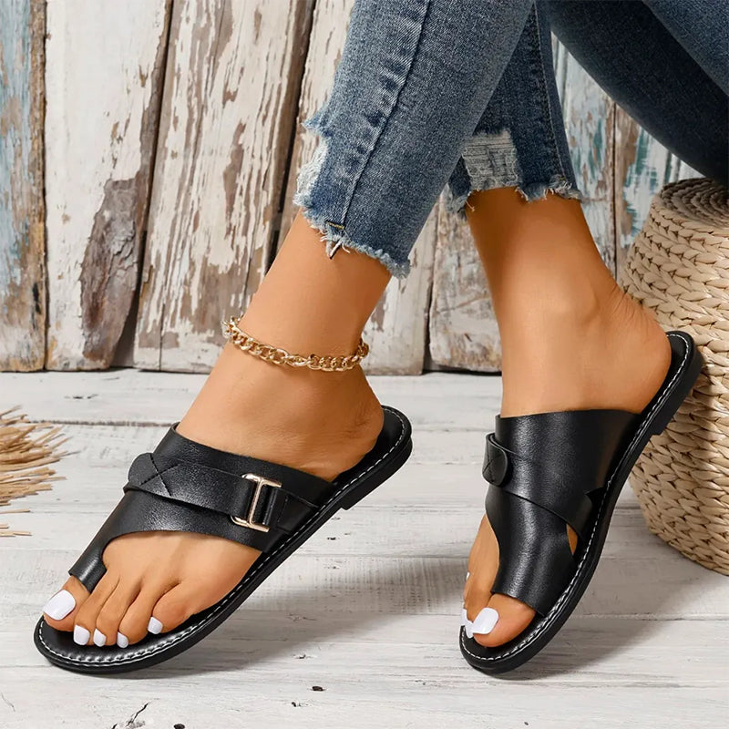 Women’s black slide sandals with double straps and metal buckle, open toe