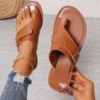 Women’s brown leather-look slide sandals with two straps and metal buckle, open toe