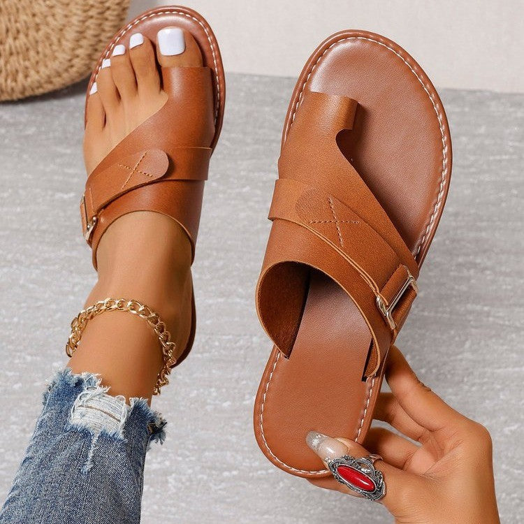 Women’s brown leather-look slide sandals with two straps and metal buckle, open toe