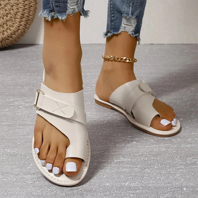 Women’s white slide sandals with two straps and adjustable metal buckle, open toe