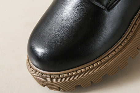 Women's black leather-look lace-up boots with round toe and textured lug sole