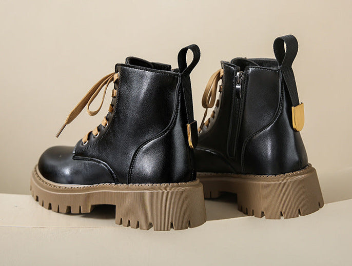 Women's black lace-up side-zip boots with chunky lug sole and tan accents