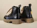 Women's black lace-up side-zip boots with chunky lug sole and tan accents