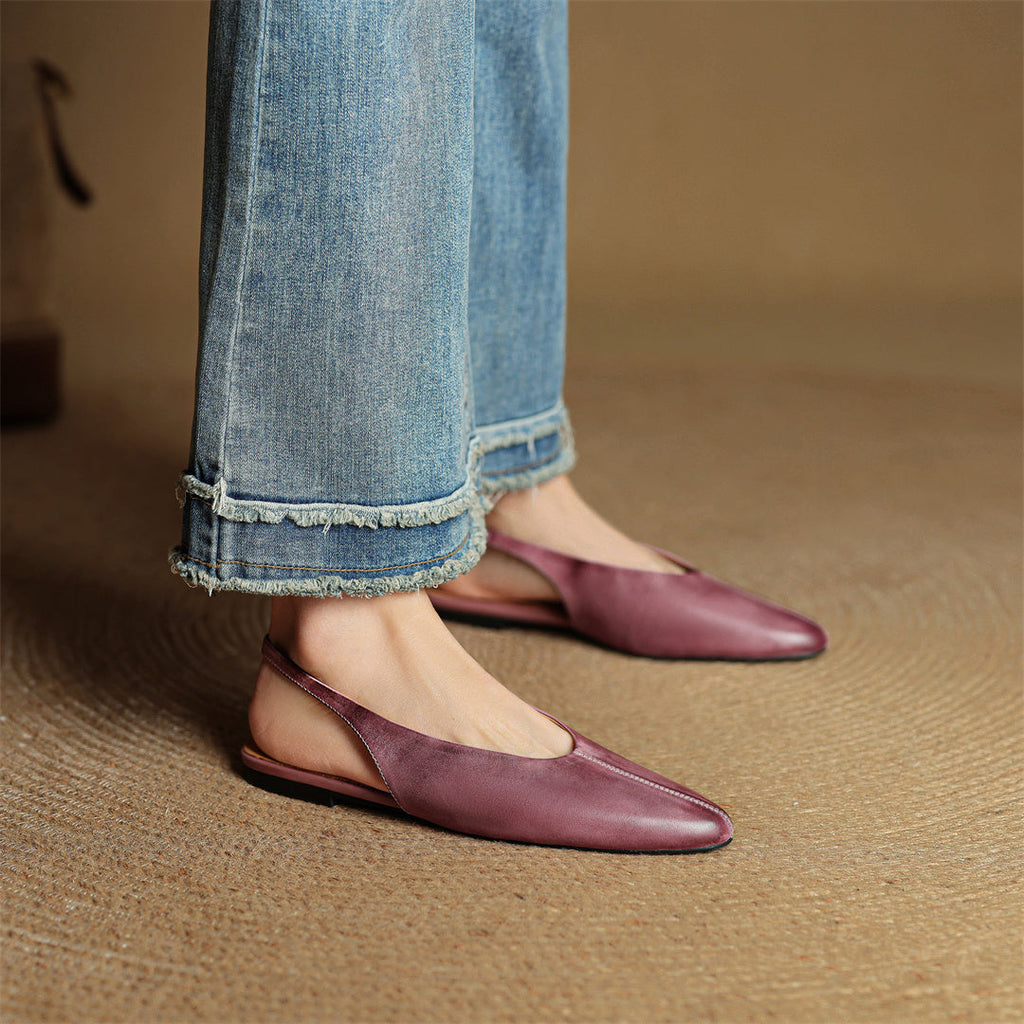 Burgundy and mauve leather slingback flats on model’s feet, pointed toe flats