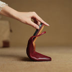 Wine red leather slingback flat with strap and low heel, cushioned footbed