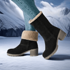 Women’s black mid-calf boots with beige fleece cuff, chunky heel, and tread sole