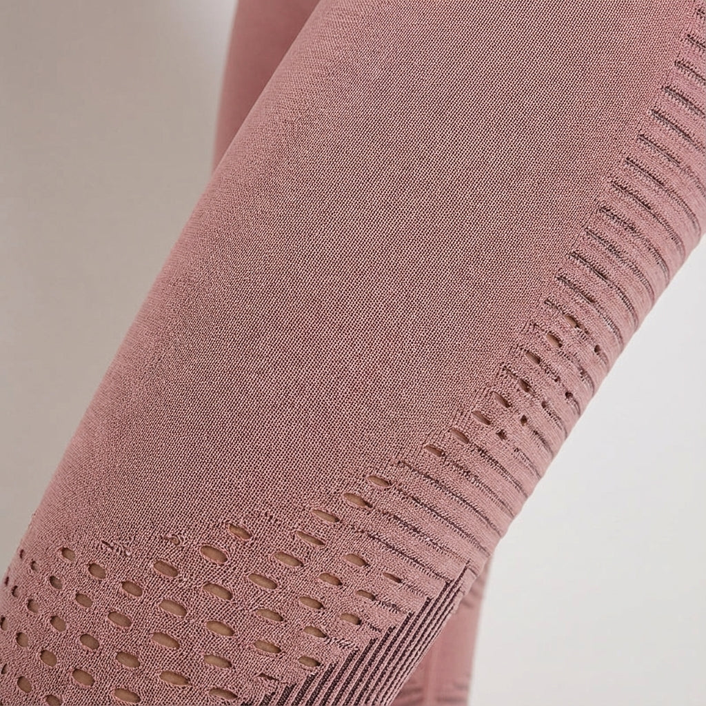 Pink legging close-up with knit texture and perforated dot detailing on the leg