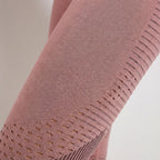 Pink legging close-up with knit texture and perforated dot detailing on the leg