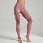 Pink high-waisted leggings with diagonal ribbed panels and perforated ankle dots