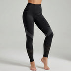 Black high-waisted performance leggings with ribbed side panels and dotted calf accents